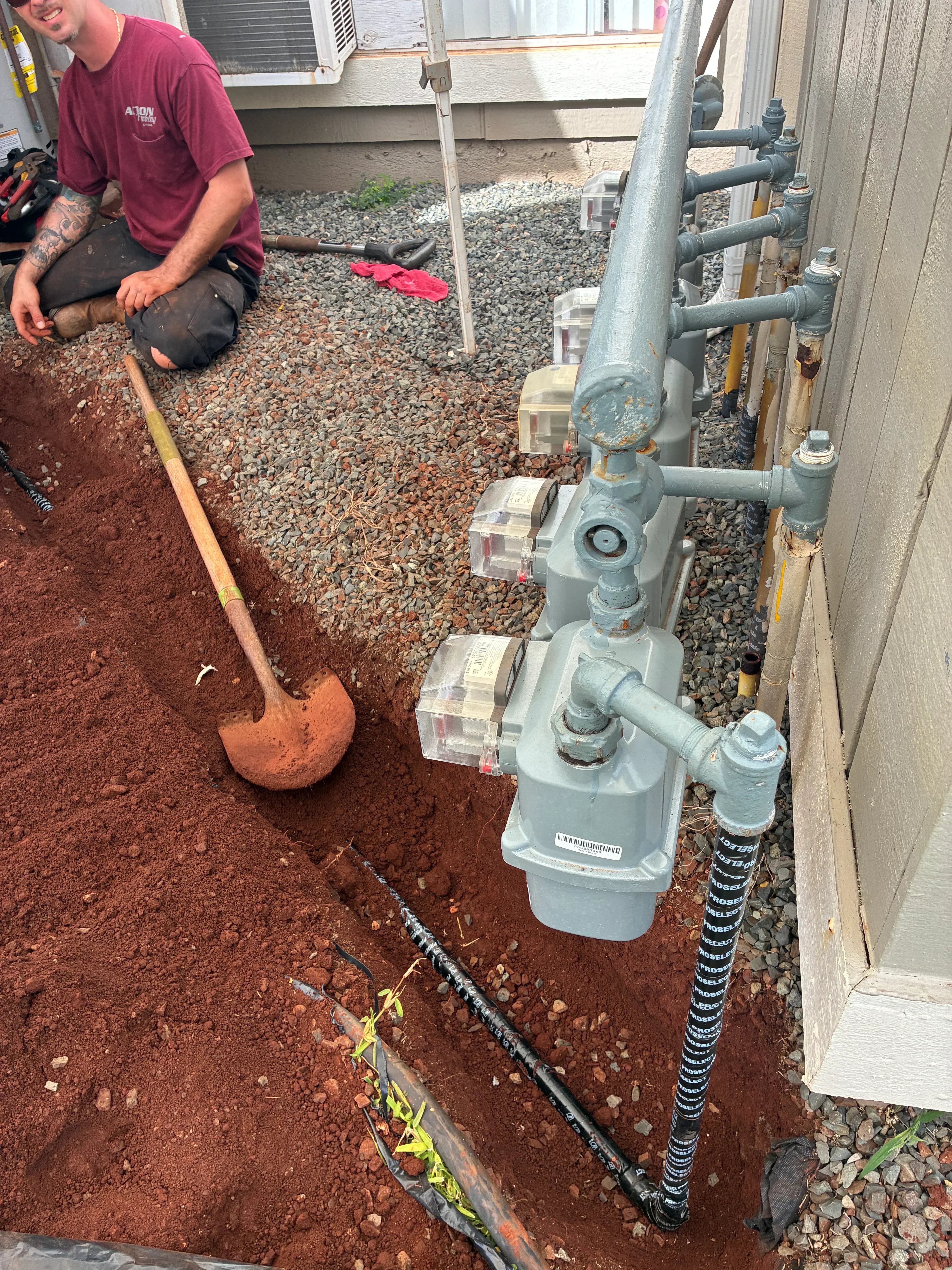 Greywater system with PVC pipes, dual tanks, valves, and underground drainage installation