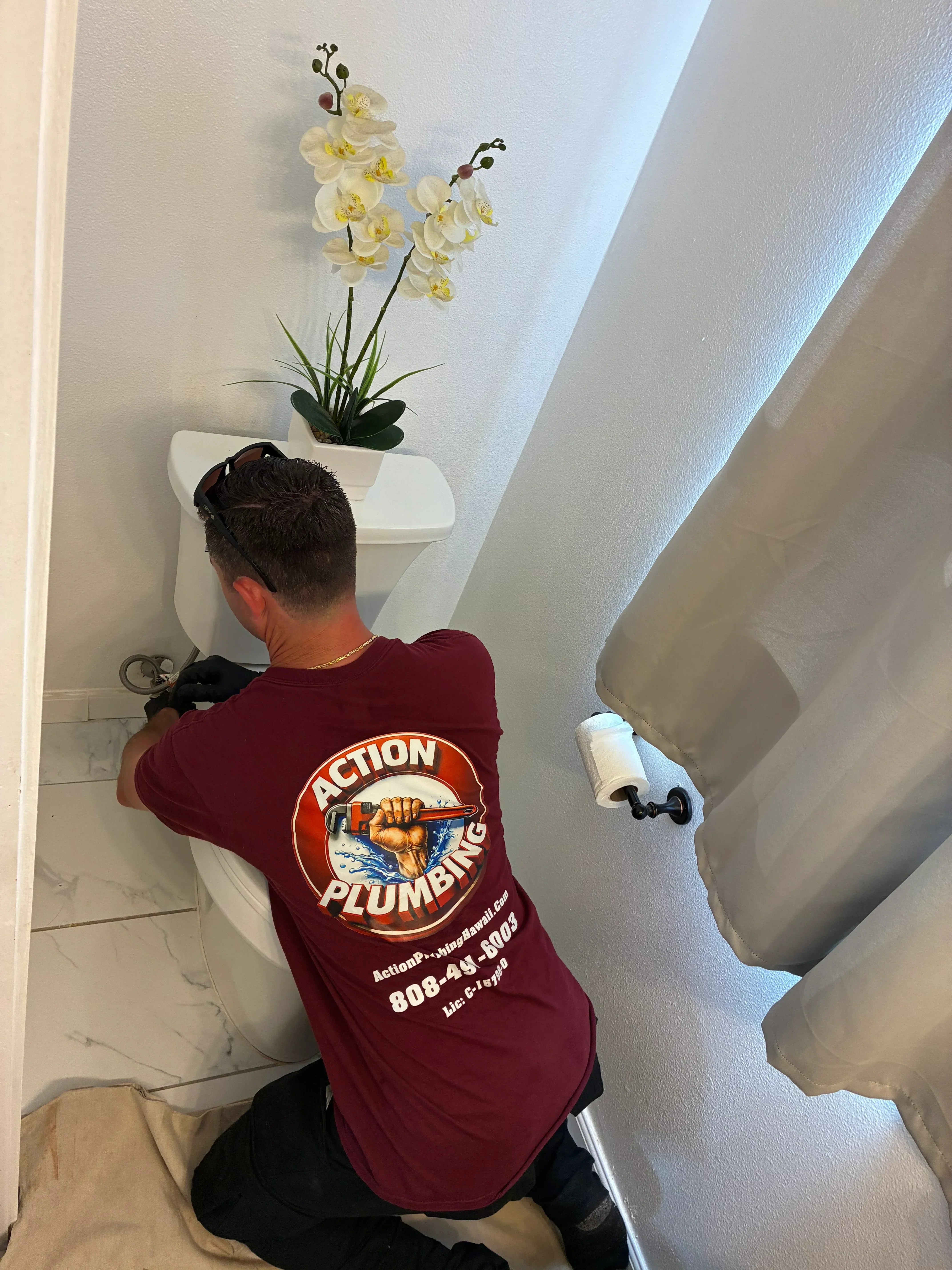 Pedestal sink installation with chrome fixtures and supply lines in white bathroom