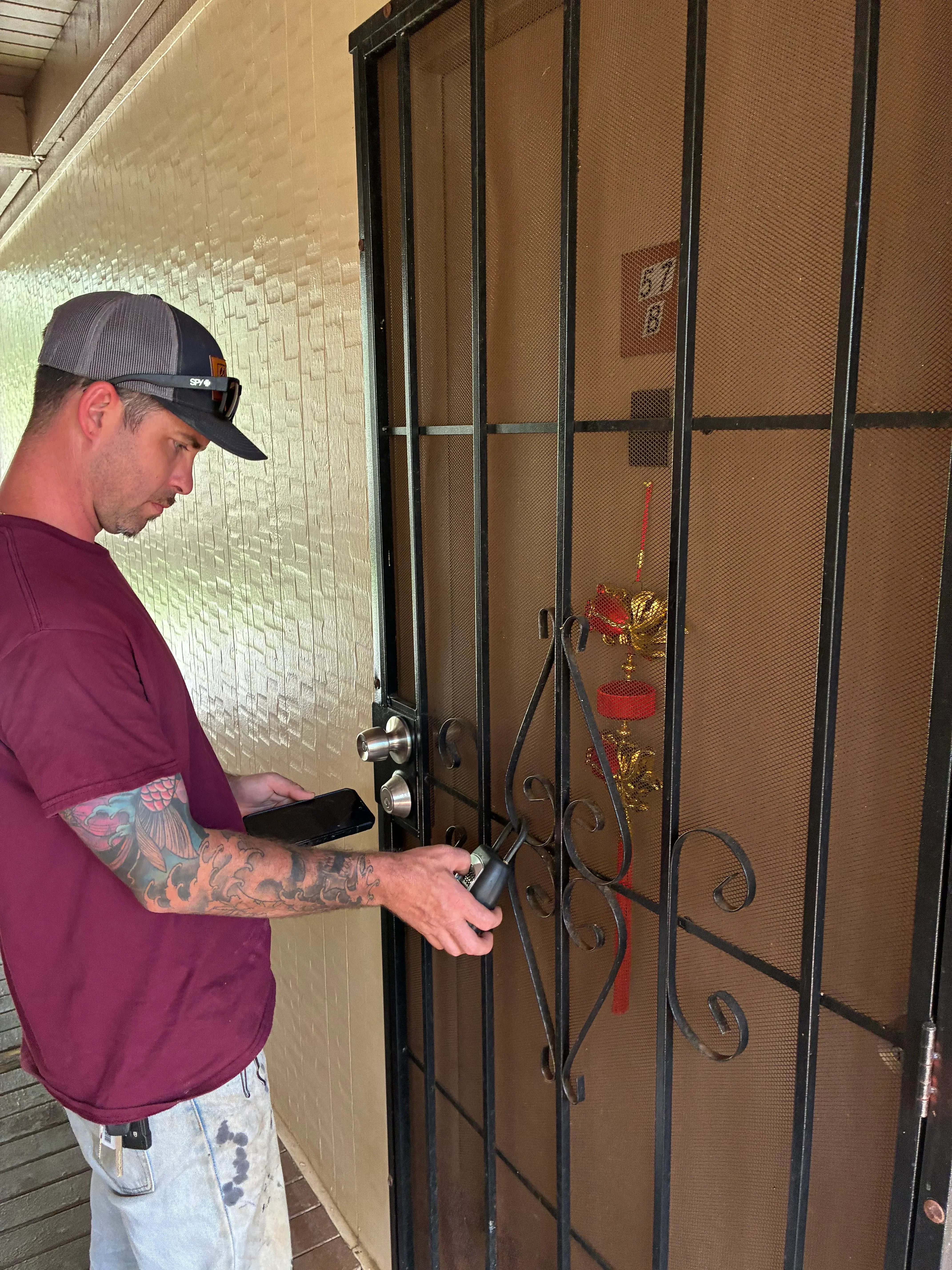 Wrought iron curtain rod with scrollwork brackets and finials installed above window