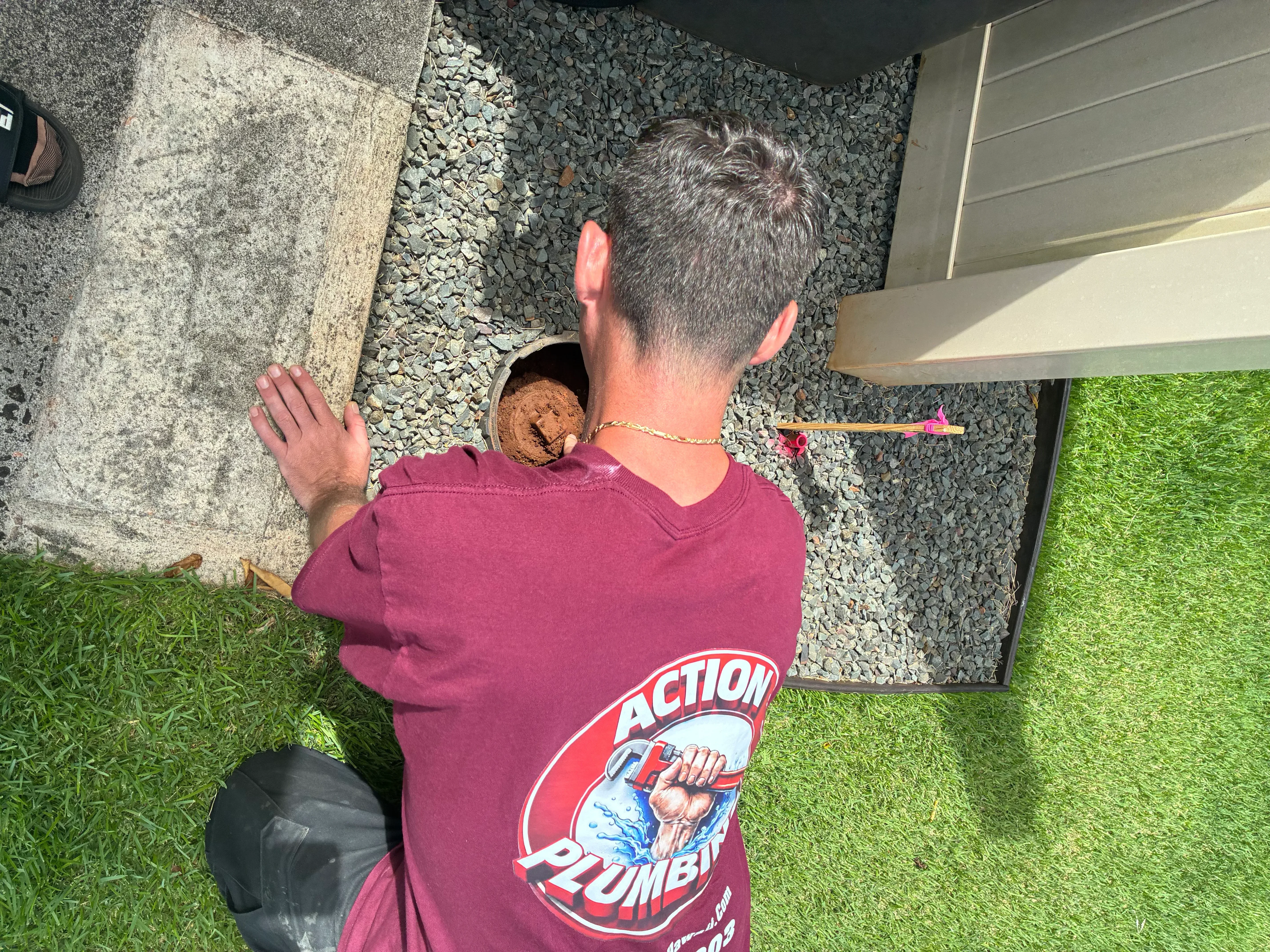Plumber accessing and cleaning residential drain line with professional equipment