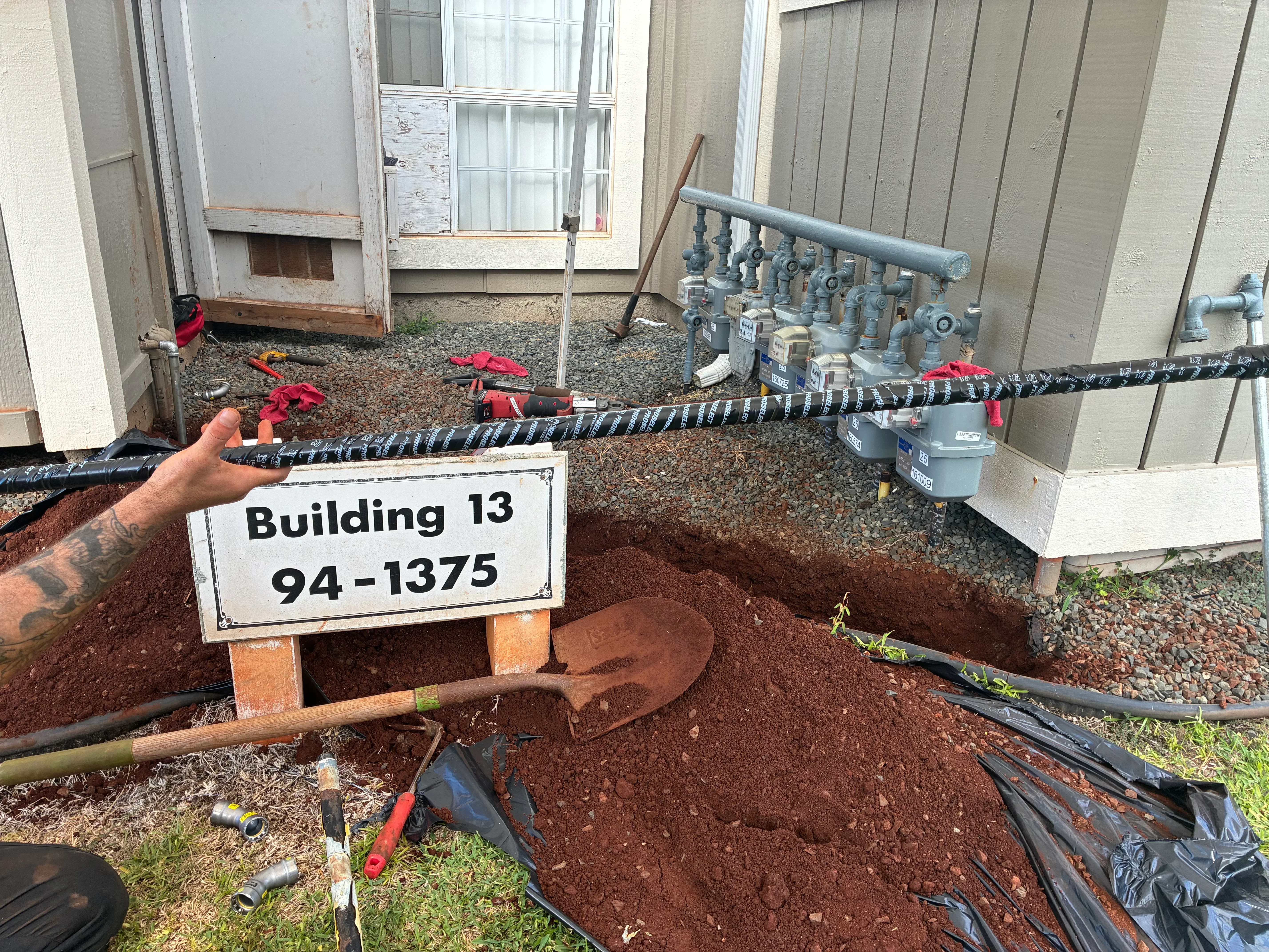 Underground PVC plumbing line with shut-off valves and meter assembly during installation